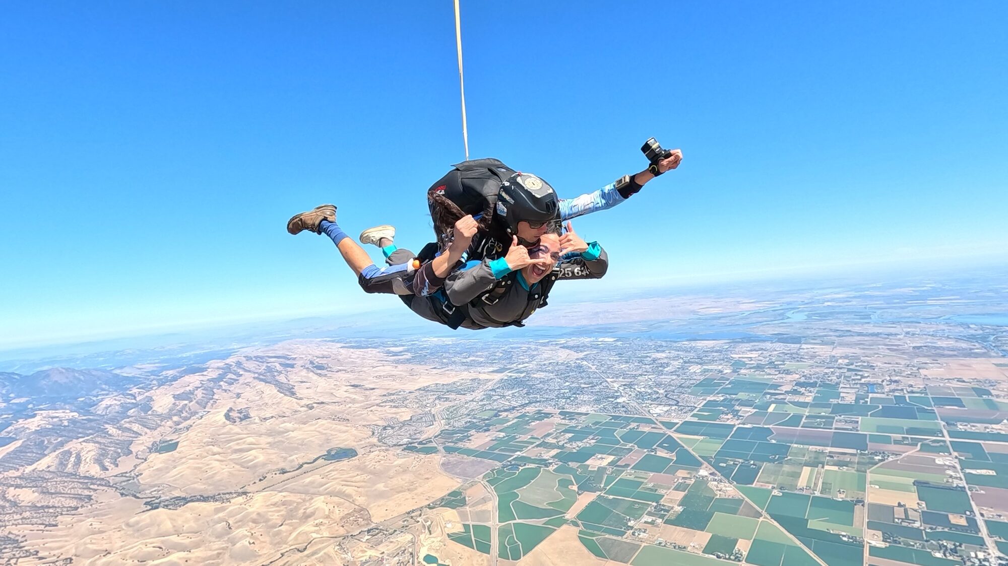 Tandem skydiver in freefall over California