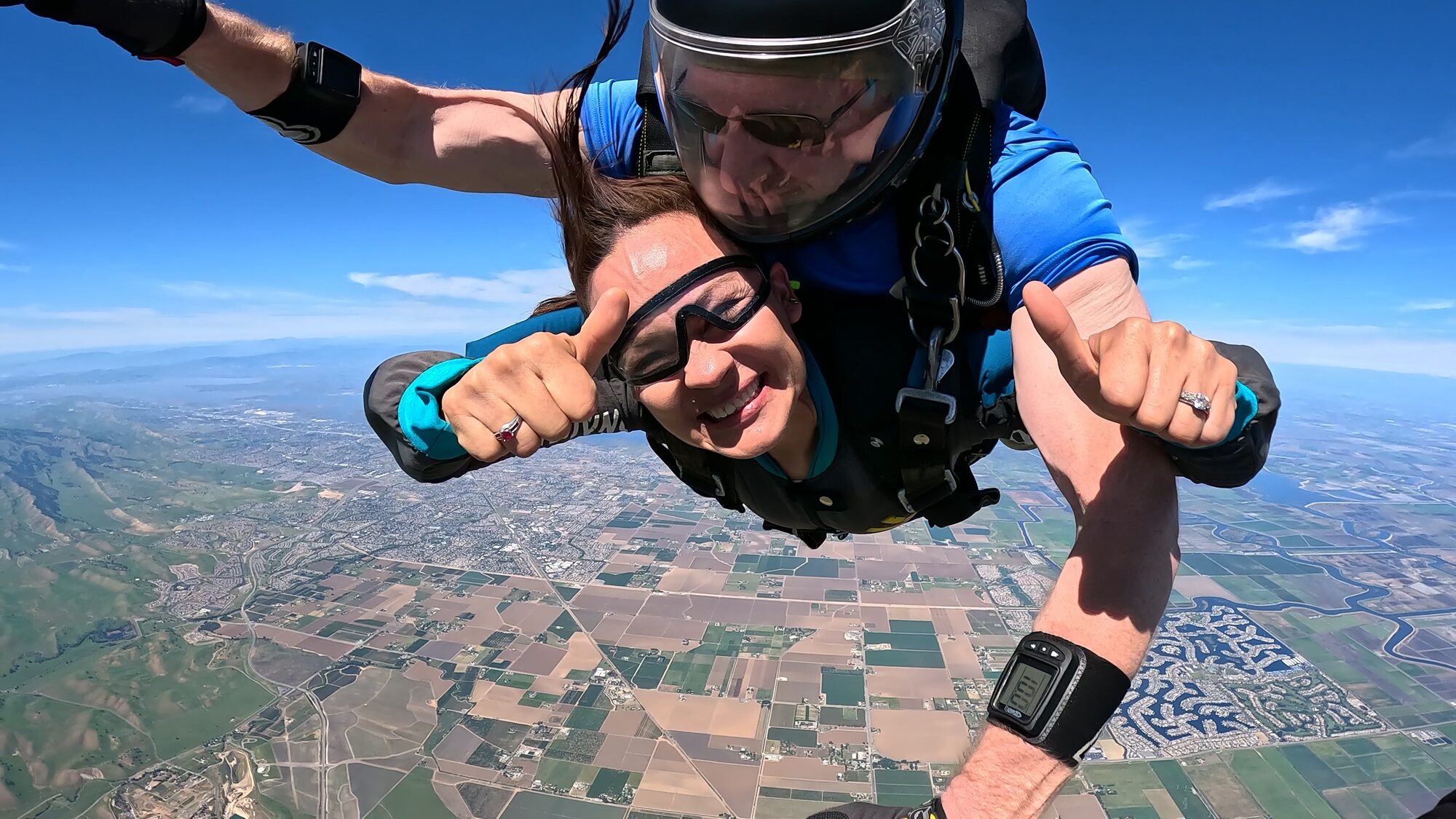 Tandem skydiver smiling in freefall